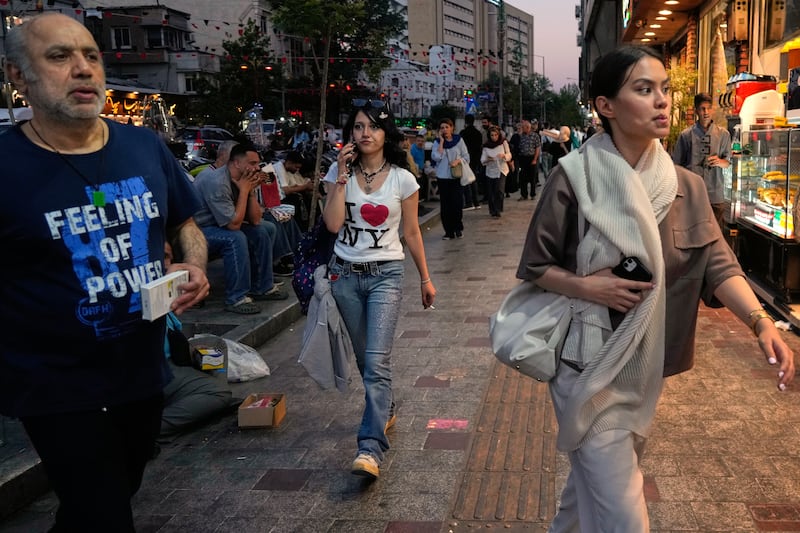 People walk along Tajrish square in northern Tehran, Monday, June 15, 2026. (AP Photo/Vahid Salemi)