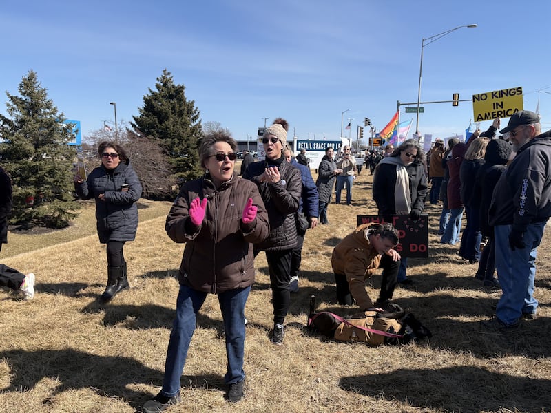 Protesters chant at a National Organization for Women rally March 8, 2025 in Crystal Lake.