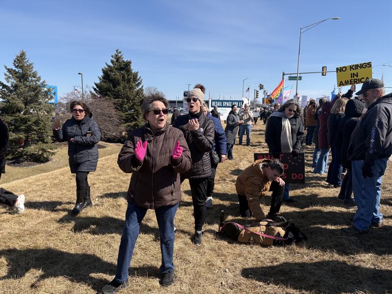 Protesters chant at a National Organization for Women rally March 8, 2025 in Crystal Lake.