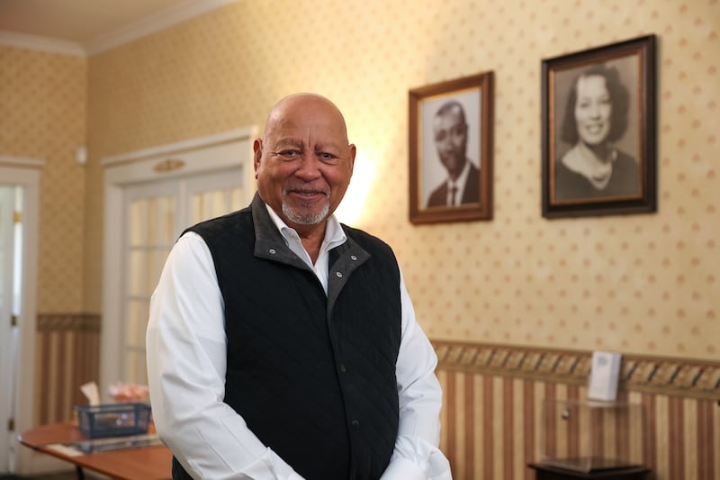 Thomas “Jeff” Jones III stands in the entryway to the Jones Funeral Home in Kankakee on Feb. 18, 2026. Jones, who took over after his father Thomas Jefferson Jones, Jr., known as Tom, has stewarded the the family business into its 70th year. Portraits of his father, Tom, and mother, Laura, hang on the wall behind him.