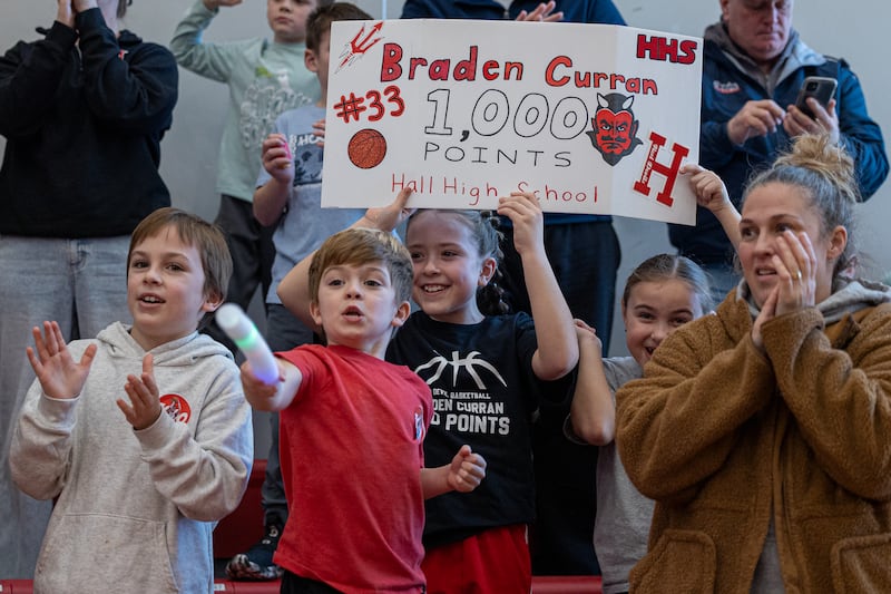 Addison Fusinetti holds sign honoring Braden Curran (33) of Hall scoring 1,000 career points on Saturday, January 31, 2026 at Hall High School in Spring Valley.