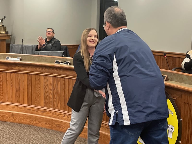 Newly-sworn Peru Police Officer Ryan Payne shakes hands Monday, Dec. 29, 2025, with Mayor Ken Kolowski after he administered the oath of office. Payne is a graduate of Ottawa Township High School and St. Ambrose University.