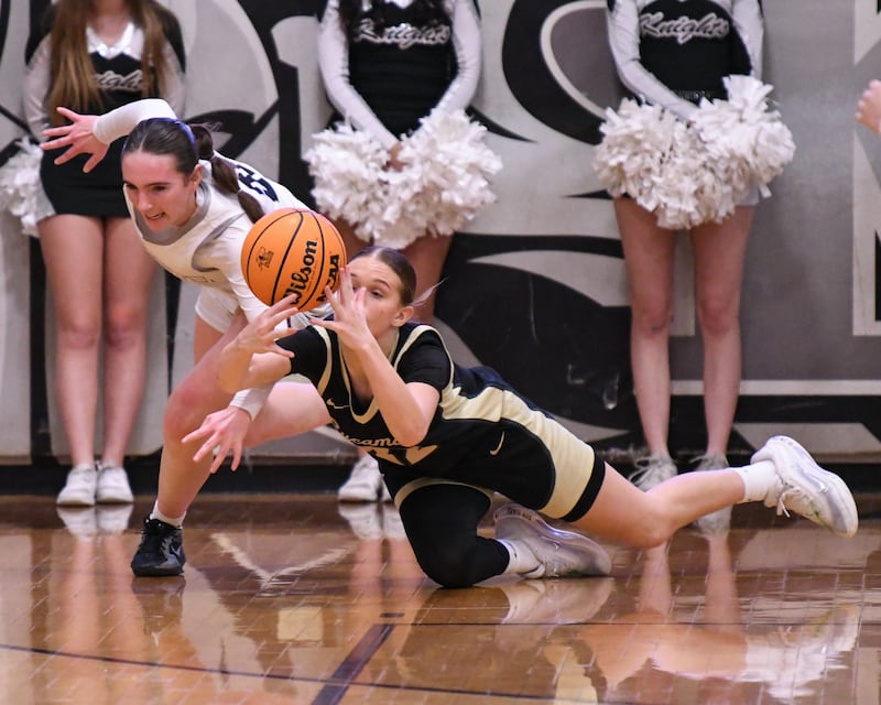Kaneland's Kyra Lilly, left, and Sycamore's Quinn Carrier (32) battle for a loose ball during the game on Wednesday Feb. 4, 2026, held at Kaneland High School.
