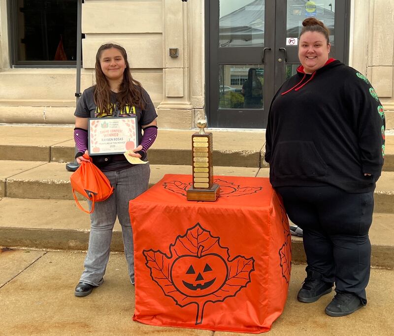 Rayven Rosas and her mother Nicole Houran stand with the Sycamore Pumpkin Festival theme contest trophy, which now bears Rosas' name after she was announced as the winner of the 2025 contest  on May 21, 2025.