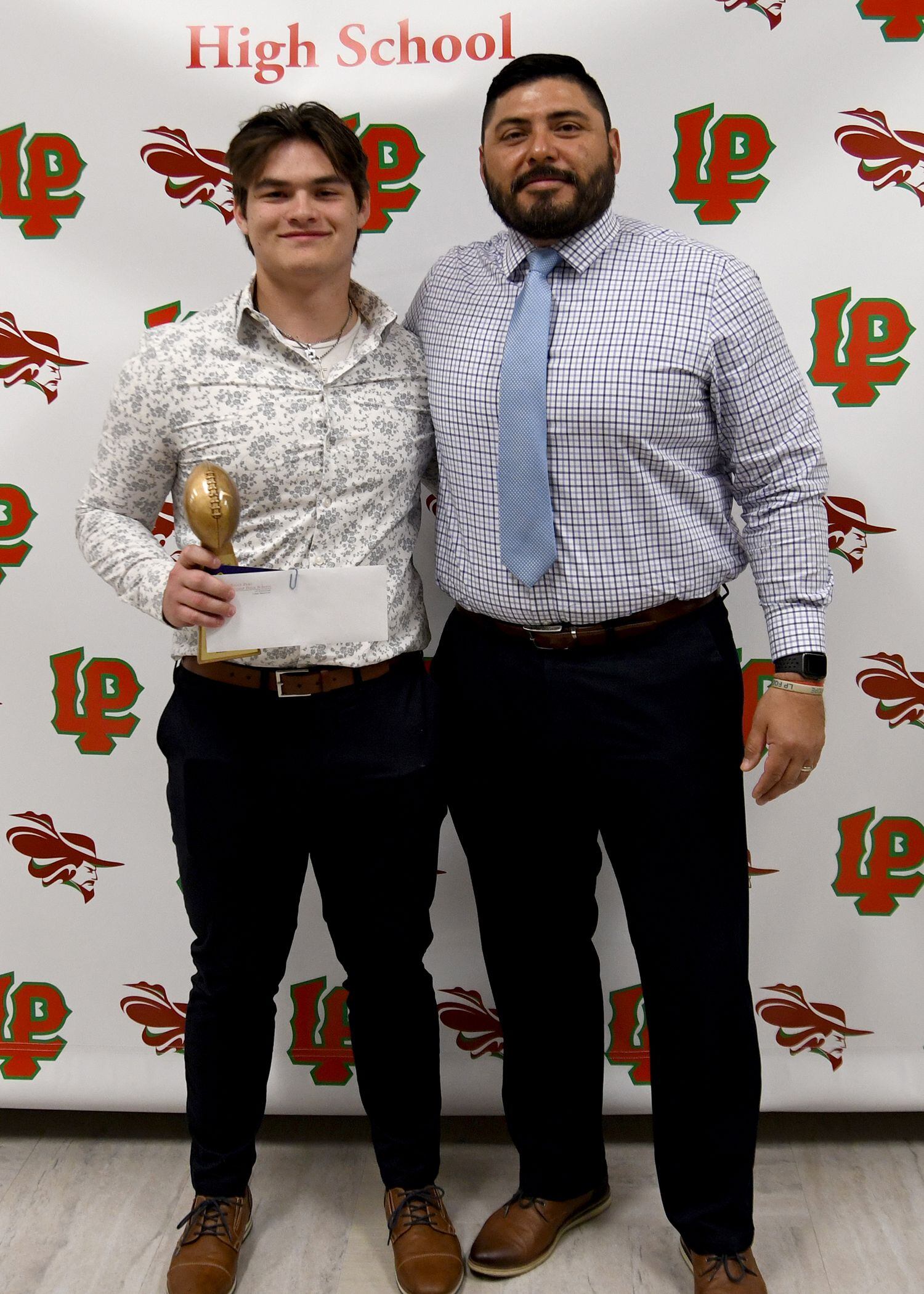 Antonio Rodriguez (left), a LaSalle-Peru Township High School senior, received the Vito Ricci Football Scholarship. This $1,000 scholarship is awarded to a team leader, who displays the character traits of LP spirit as well as a commitment to excellence. Rodriguez also received the Eddie Bray Football Scholarship, which is a $500 award given to a four-year L-P football player who displays the traits of teamwork, sportsmanship and the potential for solid academic success in higher education. The scholarships were presented by L-P football coach Jose Medina.