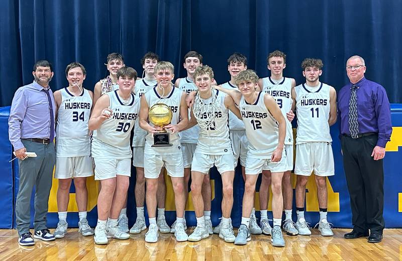 Members of the Serena Husker boys basketball team pose with the Little Ten Conference Championship trophy after defeating Earlville on Friday, Feb. 2, 2024 at Somonauk High School.