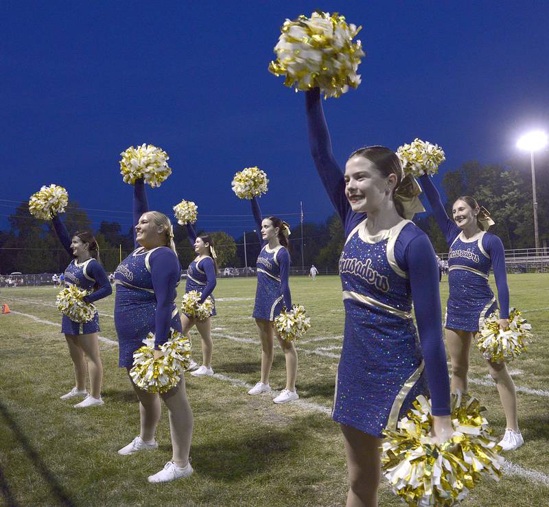 Marquette Crusader cheerleaders get the crowd revved up for the team’s Homecoming Game Friday against Aurora Central Christian .