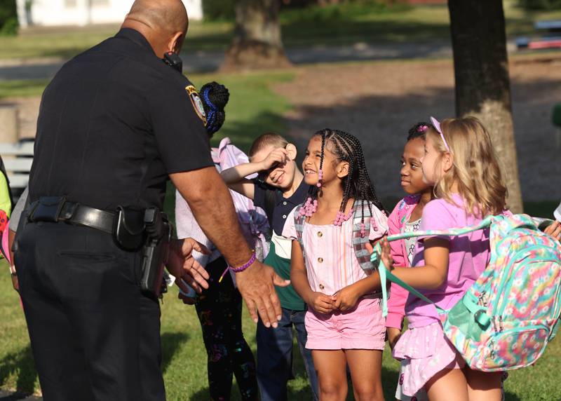 DeKalb Police Chief David Byrd greets Lincoln Elementary School students as they arrive for their first day of classes Wednesday, Aug. 14, 2024, at the school in DeKalb.