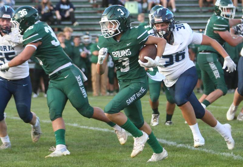 St. Bede's Stuart McGunnigal sprints down the field to score a touchdown over Bureau Valley's Blake Foster  on Friday Aug. 29, 2025 at St. Bede Academy.