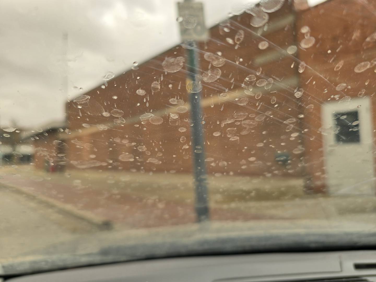 Dirty rain is splattered across a windshield on Wednesday, March 19, 2025, in downtown La Salle.