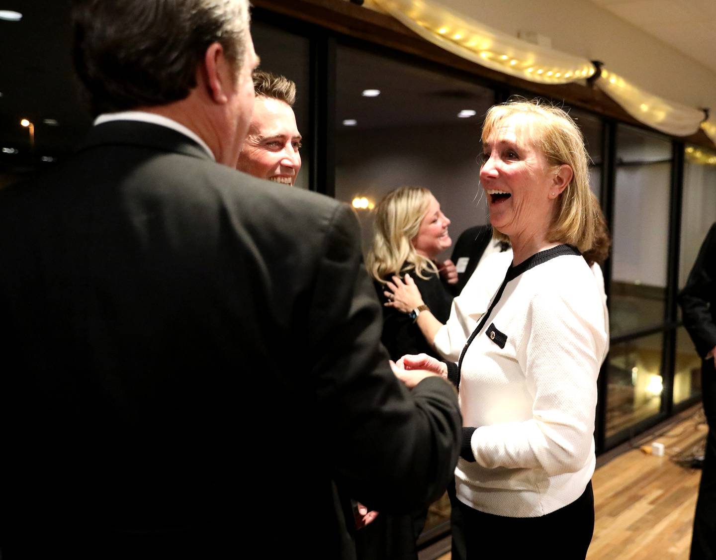 Heidi Howlett talks with Geneva Mayor Kevin Burns and her son, Charlie, after she and her husband, Chuck, were announced as the 2024 Geneva Chamber of Commerce Wood Award winners during the chamber’s annual dinner and awards ceremony on Thursday, Nov. 7, 2024 at Riverside Receptions in Geneva.