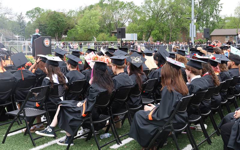 Members of the Class of 2025 listen to a speaker during their commencement ceremony on Saturday, May 17, 2025, at McCracken Field in McHenry.