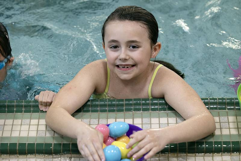 Avery Jenkins, 7, of Sterling smiles at her cache of eggs Friday, April 11, 2025, during the Sterling-Rock Falls YMCA Easter Egg Hunt.