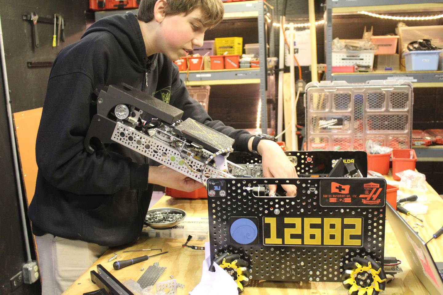 The Golden Ratio team member Josiah Ryan works on the team's robot, Curiosity, before they head to the international FIRST Competition in Houston next month.