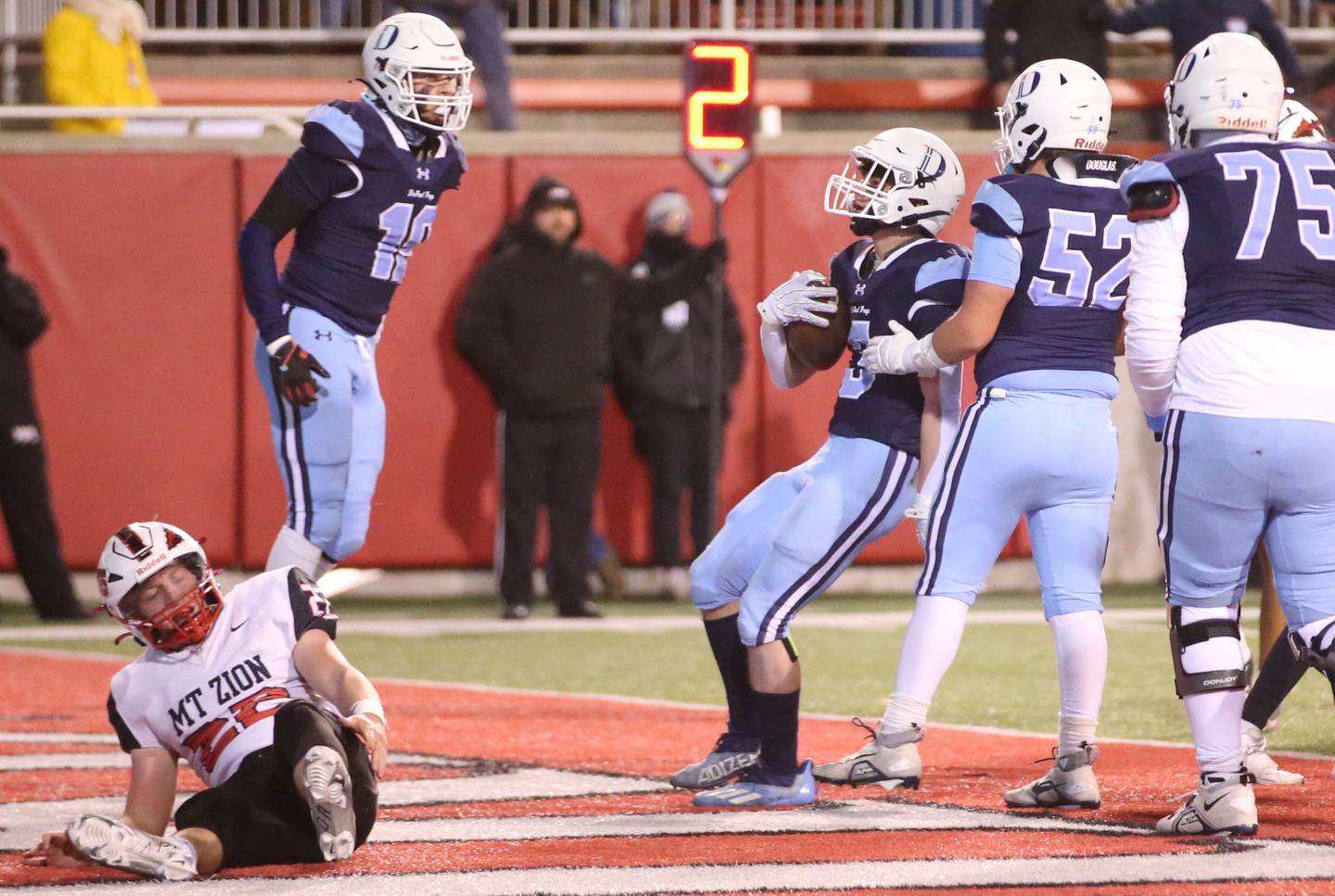 DePaul's Nick Martinez runs in for a touchdown as Mt. Zion's Jonny Jordan lays in the end zone during the Class 4A State football championship on Friday, Nov. 29, 2024 at Hancock Stadium in Normal.