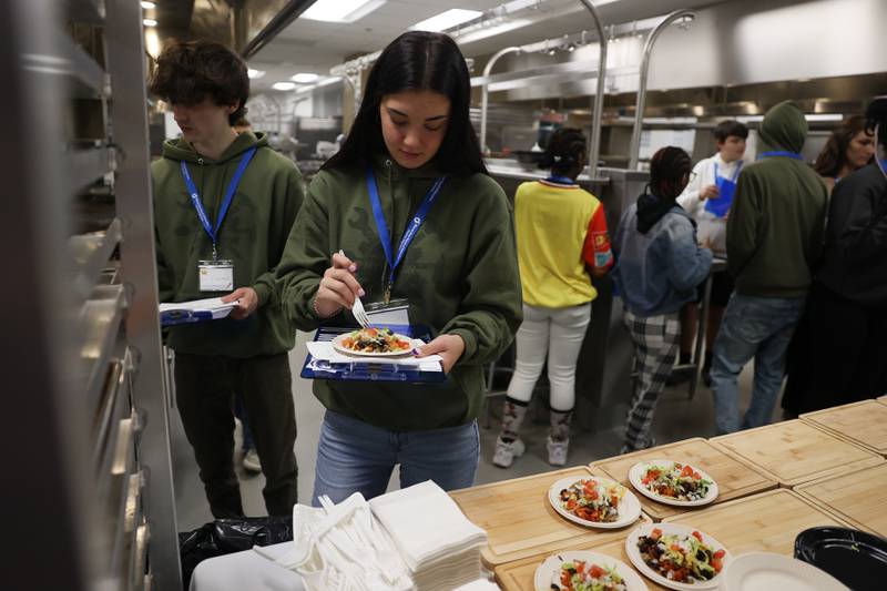 Kadence Chamness, a Senior at Mt. Vernon High School, tries one of the dishes at a nutritional and wellness event hosted by Joliet Junior College on Friday, April 21, 2023 in Joliet.
