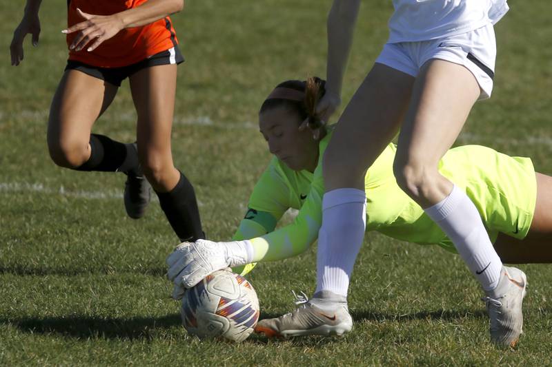 Crystal Lake Central's Addison Cleary dives for the ball as the feet of Huntley's Maddie Rumachik during a Fox Valley Conference soccer game on Tuesday, April 9, 2024, at Crystal Lake Central High School.
