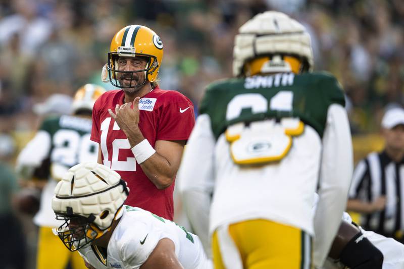 Green Bay Packers quarterback Aaron Rodgers (12) speaks with his teammates during NFL football practice at Packers Family Night on Friday, Aug. 5, 2022, at Lambeau Field in Green Bay, Wis. (Samantha Madar/The Post-Crescent via AP)
