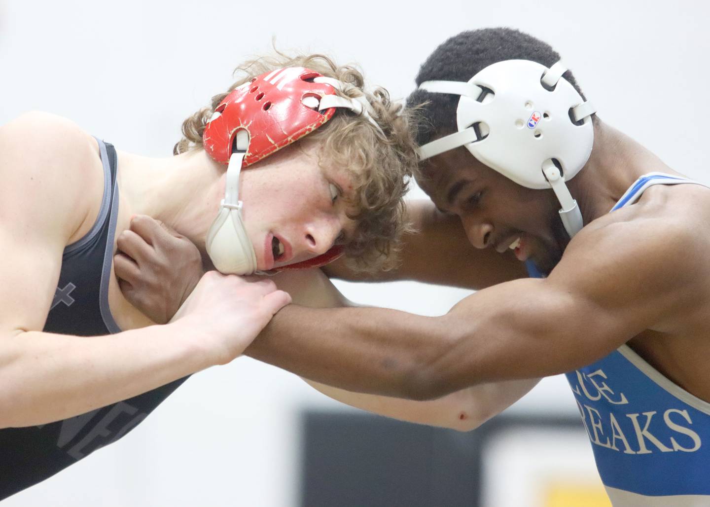 Woodstock’s Taqiuldin Baker, right, battles Marian’s Cam Spiniolas at 126 pounds in boys wrestling IHSA Class 2A Regional championship bout action on Saturday, Jan. 31, 2026, at Harvard High School in Harvard.