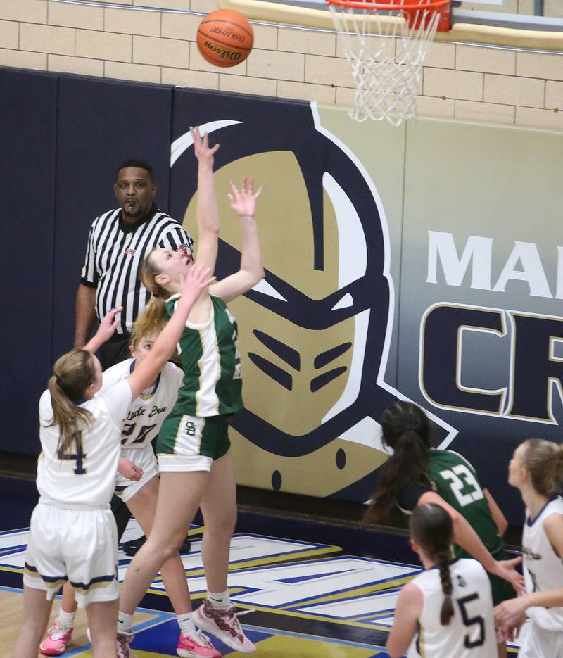 St. Bede's Ashlyn Ehm dribbles in the lane to shoot a baseket over Marquette's Hunter Hopkins and Kaitlyn Davis on Monday, Nov. 27, 2023 in Bader Gym at Marquette High School.