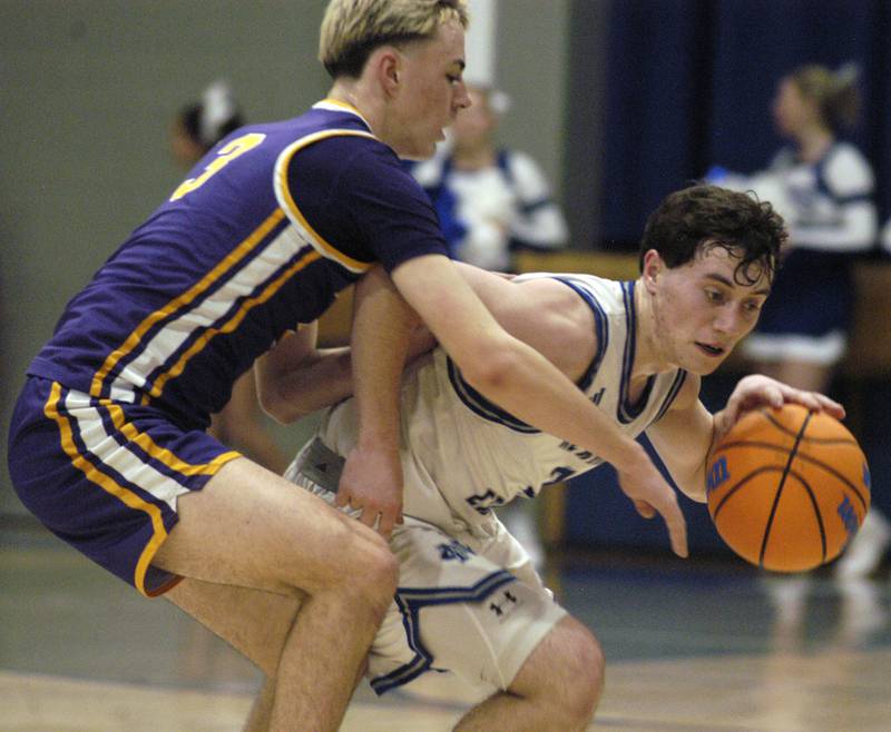 Newman's Garret Matznick drives around  Mendota's  Dane Doyle.  The 18-0 Newman Comets defeated  the 14-4 Mendota Trojans 67-66 at Newman High School. The game took place on Tuesday, January 13, 2025.