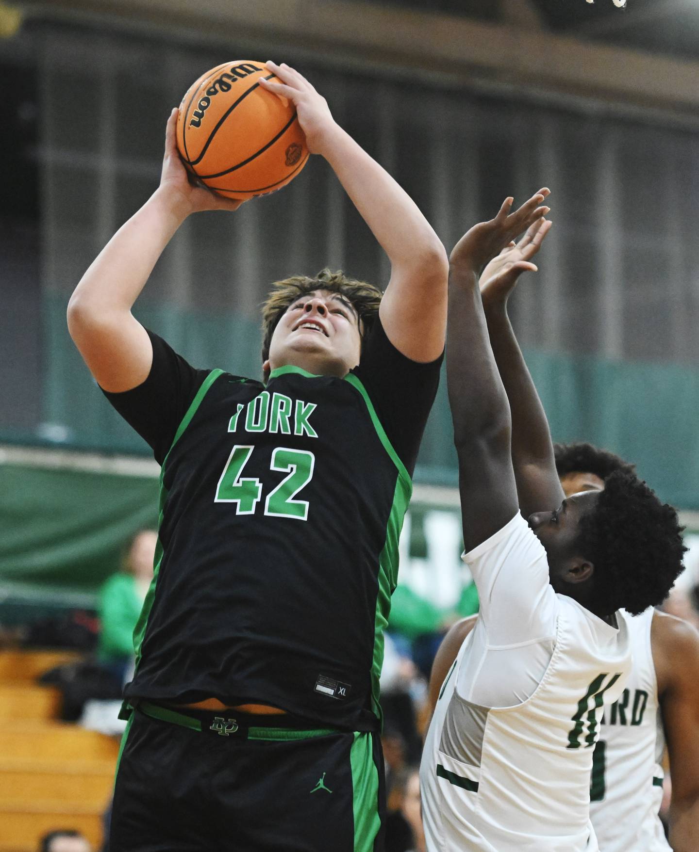 York's Costa Kampas, left, shoots against the defense of Glenbard West's Teyion Oriental during Friday's game in Glen Ellyn.