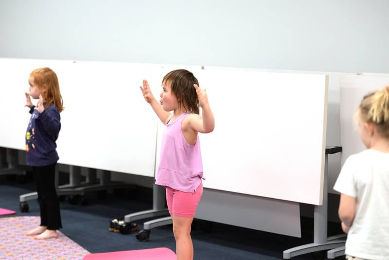 Children including Millie Ryan of La Grange Park participate in Earth Day Yoga at La Grange Park Library Sunday April 13, 2025. The event included pretending to pose as various earth related elements including a cloud and wind.