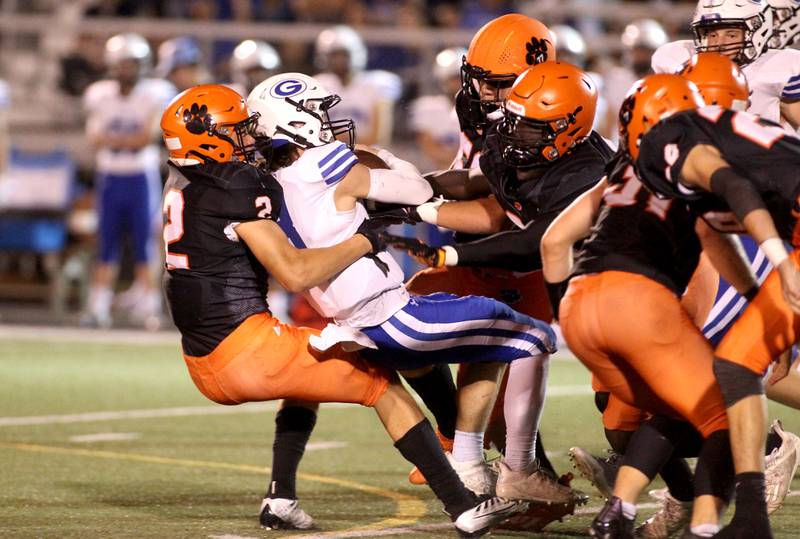Wheaton Warrenville South’s Charlie Butt (2) sacks Geneva quarterback Nate Stempowski during a game at Wheaton Warrenville South on Friday, Sept. 16, 2022.