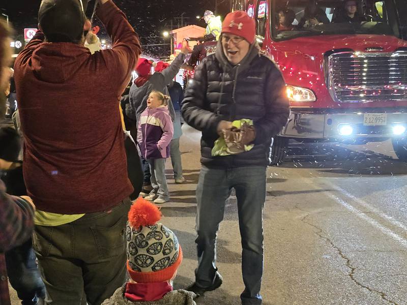 Children received candy Saturday, Dec. 7, 2024, on the Holiday Magic Lighted Santa Parade route in Marseilles.
