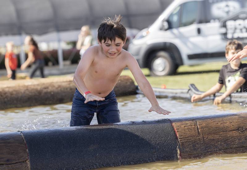 Jadon Bollman, 7, slips off the log Saturday, October 5, 2024, at the Lumberjack Show.