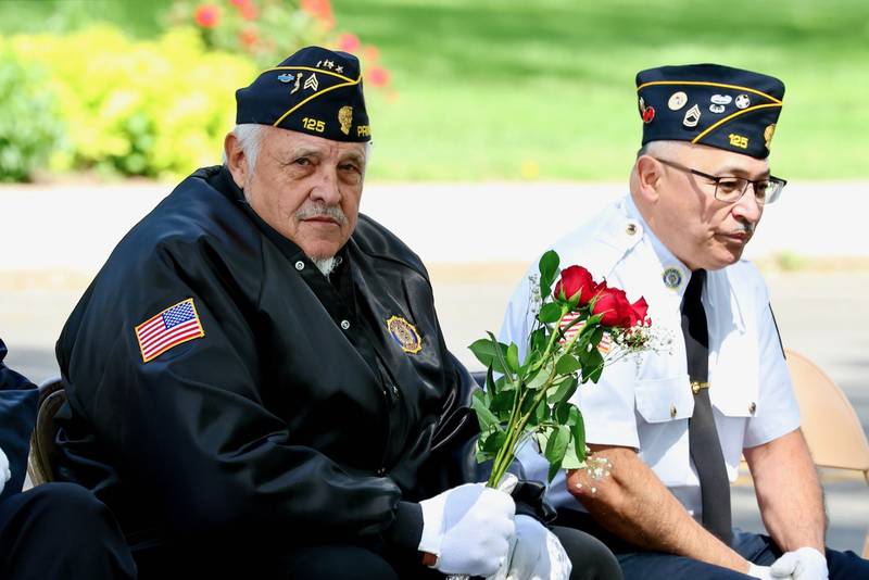 Veterans Vern Sondgeroth (left) and Hector Gomes of Princeton listen to Monday's Memorial Day Services in Princeton.
