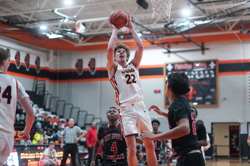 St. Charles East's Cooper Jensen (22) shoots the ball in the post against East Aurora during the 64th annual Ron Johnson Thanksgiving Basketball Tournament at St. Charles East High School on Monday, Nov 20, 2023.