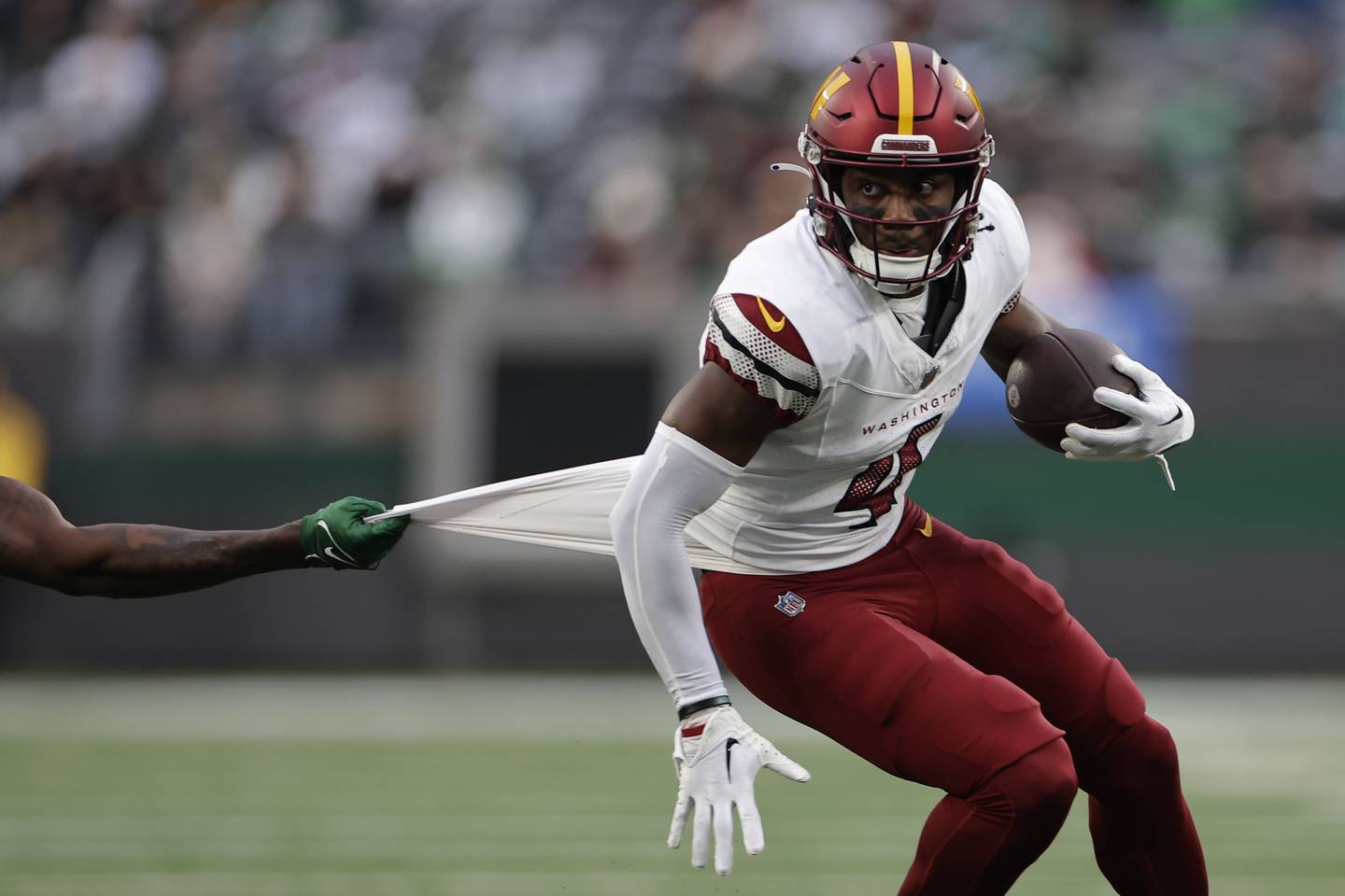 Washington Commanders wide receiver Curtis Samuel (4) carries the ball against the New York Jets during the second half of an NFL football game, Sunday, Dec. 24, 2023, in East Rutherford, N.J.