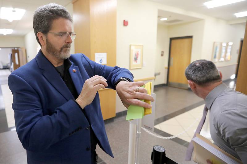 McHenry County Clerk Joe Tirio checks his watch just before 8 a.m. Monday, Oct. 27, 2025, the first day of candidate filing for the Spring 2026 primary election. Candidates in line by 8 a.m. get a chance to appear first on the ballot.