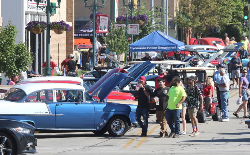 Crowds of people check out the vintage cars on South California Street in Sycamore Sunday, July 31, 2022, during the 22nd Annual Fizz Ehrler Memorial Car Show. Most of downtown Sycamore was filled with classic cars for the show.