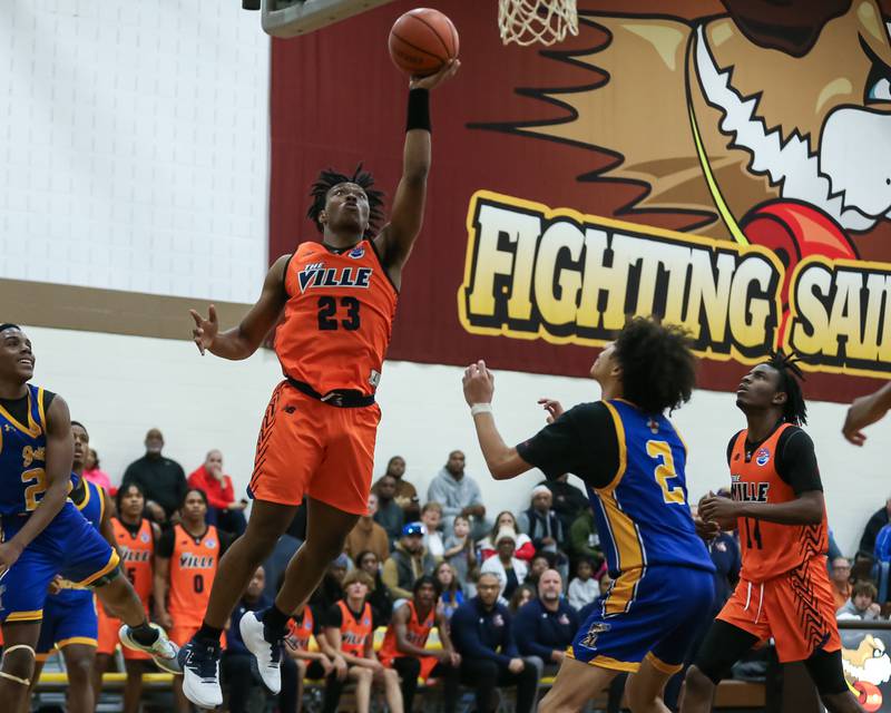 Romeoville's DJ Porter Jr (23) puts in a lay up in the WJOL Tournament Championship game. Nov 25, 2023.