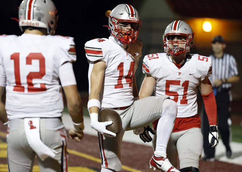 Palatine's Kole Fager (14) celebrates a touchdown Friday, Sept. 27, 2024 in Schaumburg.