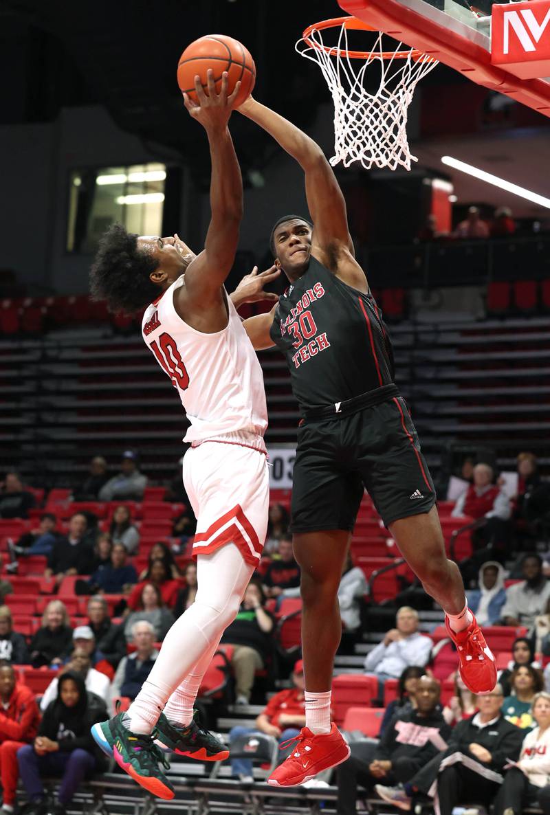 Northern Illinois' Zion Russell tries to score over Illinois Tech's Garrison Carter during their game Monday, Nov. 13, 2023, at the NIU Convocation Center in DeKalb.