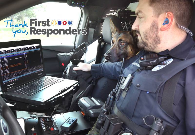 Sycamore Police K-9 officer Greyson Scott and his belgian malinois Wes look at the computer in their cruiser Thursday, April 18, 2024, at the Sycamore Forest Preserve.