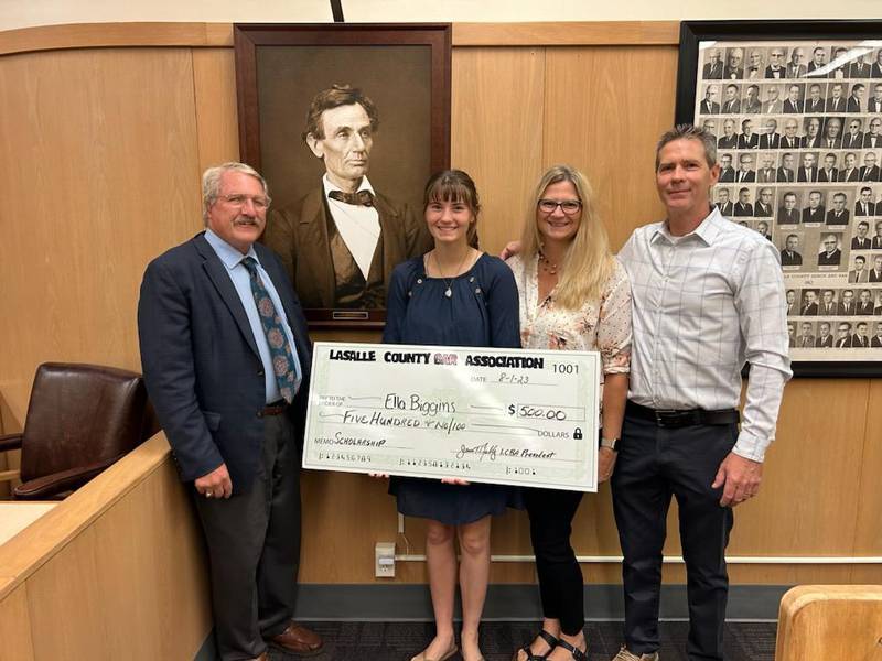 Ella Biggins (second from left), joined by parents Becky and Ed receives a $500 scholarship dated Aug. 1, 2023, from the La Salle County Bar Association at La Salle County's downtown courthouse. At the far left is La Salle County Bar President Jim Reilly.