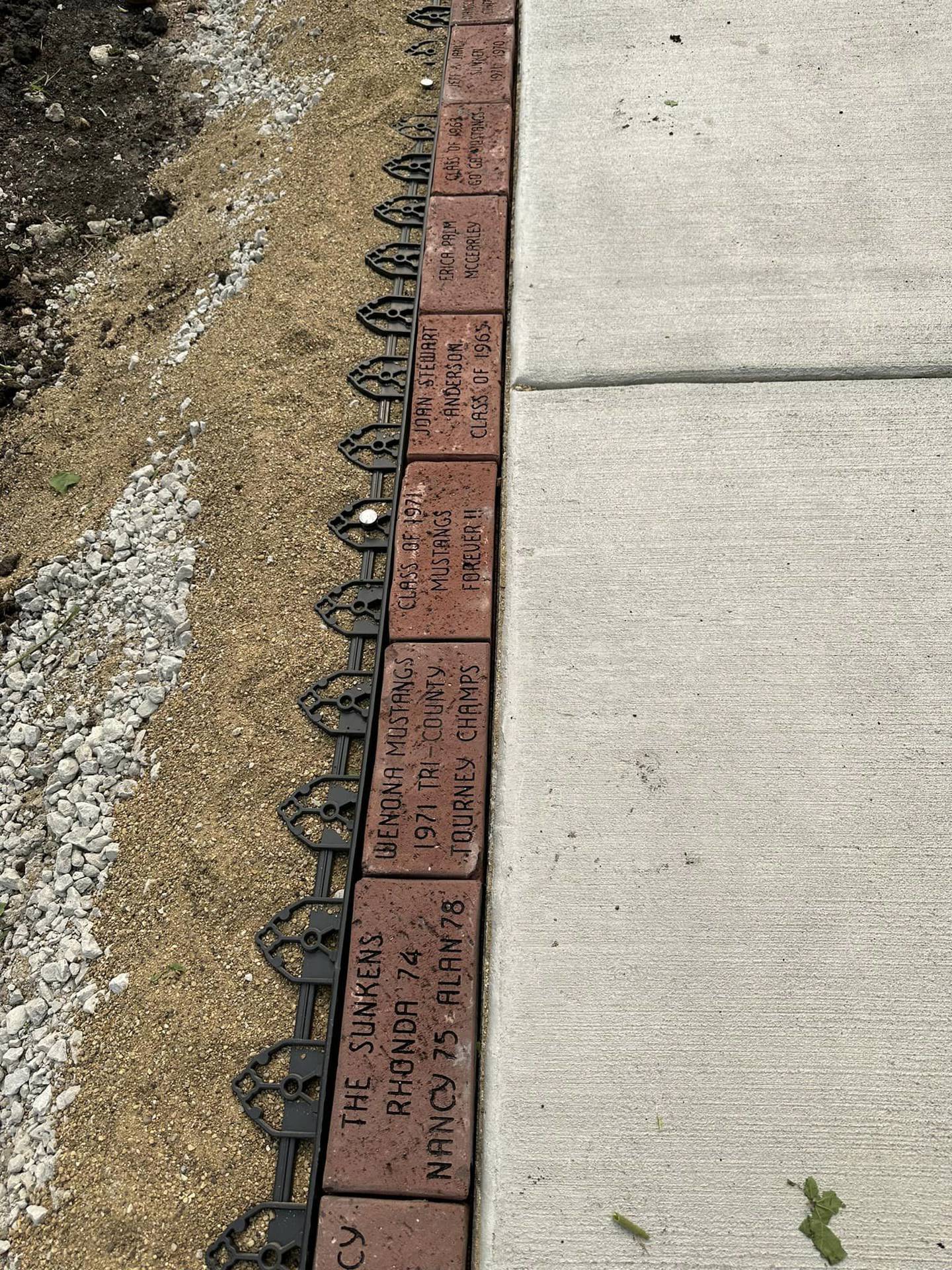 A few of the 414 memorial bricks that now line the sidewalk of Fieldcrest Middle School in Wenona. A dedication ceremony was held Saturday, Aug. 12, 2023, after renovations crowned by the bricks salvaged from a demolished portion of the campus
