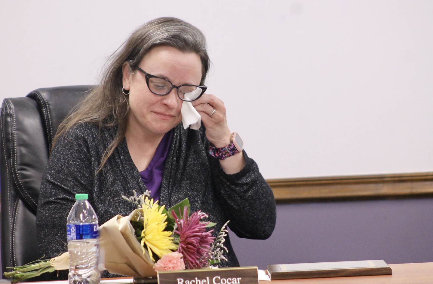 Rachel Cocar wipes her eyes on Wednesday, May 10, 2023, as she prepares to make a few comments as she ends her term as a member of the Dixon Public Schools Board of Education. She also vacated the office of board vice president.