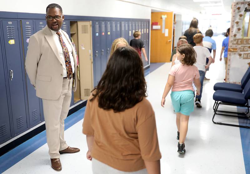 Harvard School District 50 Superintendent Brandon White talks with students as they return to their classrooms at Jefferson Elementary School during the first day of school on Wednesday, Aug. 13, 2025, in Harvard. White was previously was the superintendent of Cary School District 26.