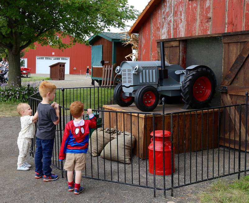 Kids watch an animated tractor at Kuiper’s Pumpkin Farm and Apple Orchard in Maple Park on Saturday, Sept. 24, 2022.