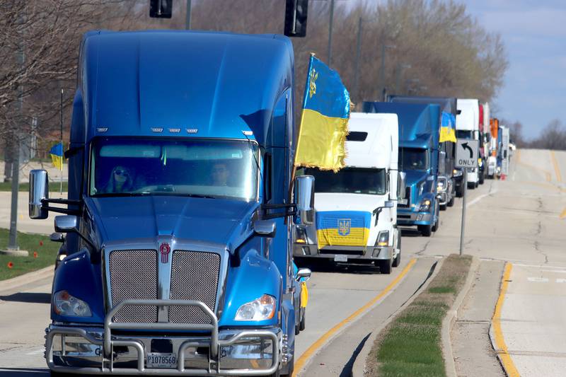 Drivers travel on Beverly Road in Hoffman Estates on Saturday morning as they begin the Deblockade Mariupol truck protest rally hosted by Help Ukraine Foundation LTD to bring attention to the blockade of Mariupol.