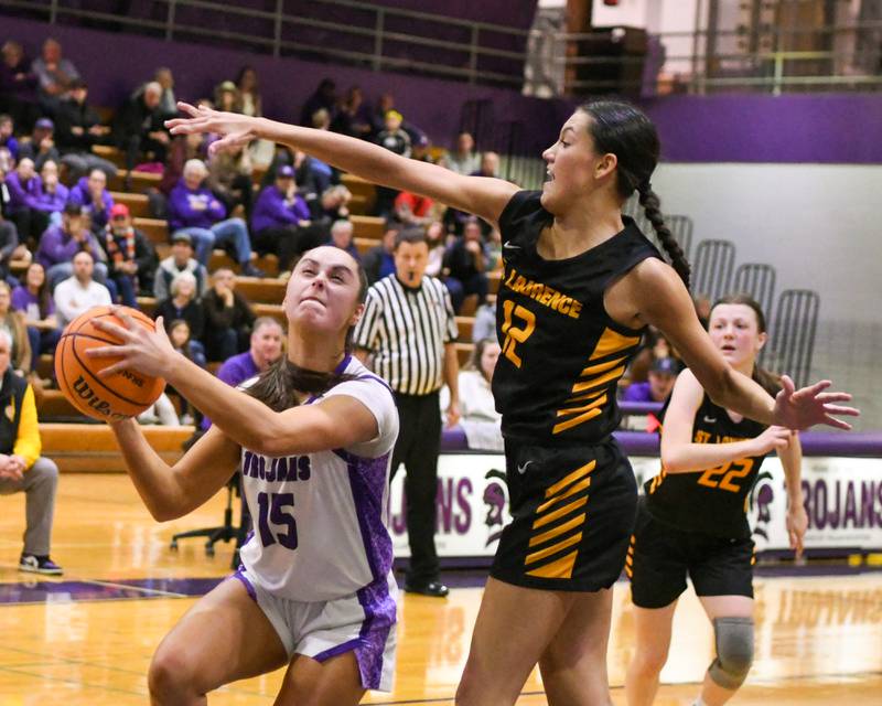 Downers Grove North's Adysen Fanta (15) makes a basket with less than 17 seconds left during the 4A regional championship game giving Downers Grove North the lead while being defended by St. Laurence's Elle Rice (12) on Thursday Feb. 19, 2026, held at Downers Grove North High School.