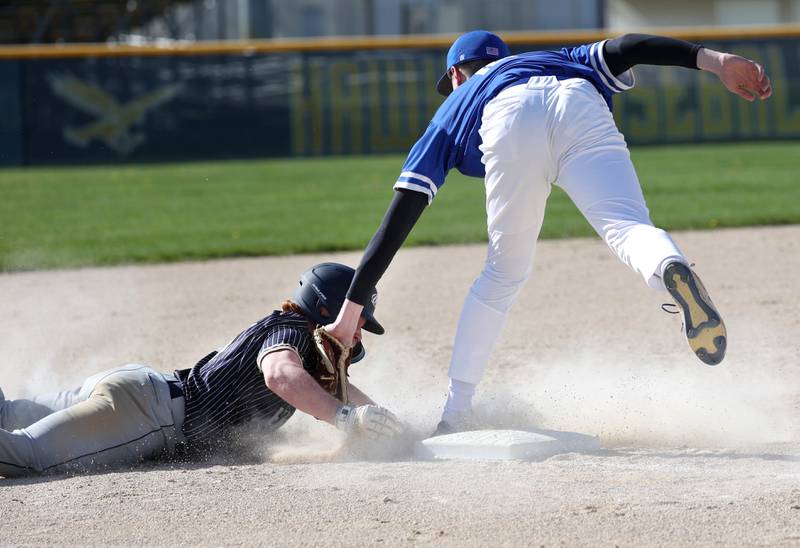 Hinckley-Big Rock's Max Hintzsche tags out Hiawatha's Tommy Butler as he tries to steal third Tuesday, April 29, 2025, during their game at Hiawatha High School in Kirkland.