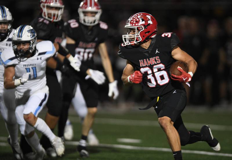 Maine South’s Michael Dellumo cuts the corner against Prospect in a Thursday night football game in Park Ridge on September 15, 2022.