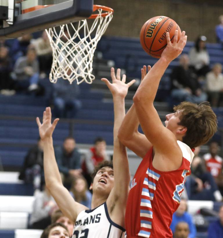 Marian Central's Christian Bentancur shoots the ball over Cary-Grove's Zach Bauer during a non-conference basketball game Monday, Dec.19, 2022, at Cary-Grove High School in Cary.