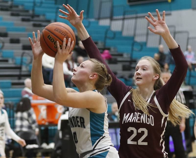 Woodstock North’s Caylin Stevens drives to the basket in front of Marengo's Dayna Carr during a Kishwaukee River Conference girls basketball game Monday, Jan. 29, 2024, at Woodstock North High School.